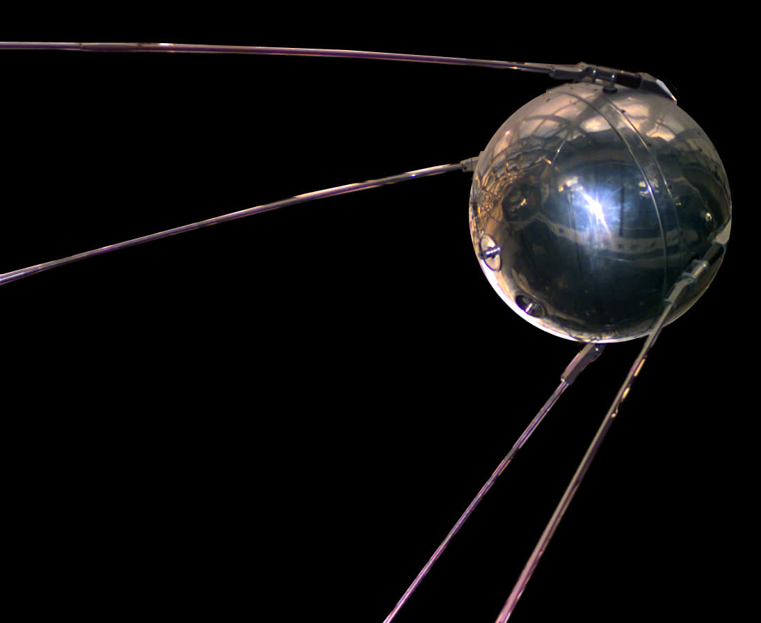 A replica of the Sputnik 1 satellite, a polished metal sphere with four long antennas
